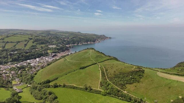 Drone view of Combe Martin surrounded by lush greenery with Lester Cliff on the north Devon coast