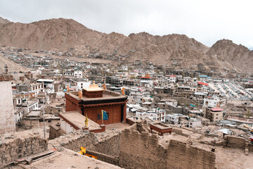 Panoramic view of Leh city in Ladakh, India, nestled in Himalayan mountains, dramatic brown ridges,...