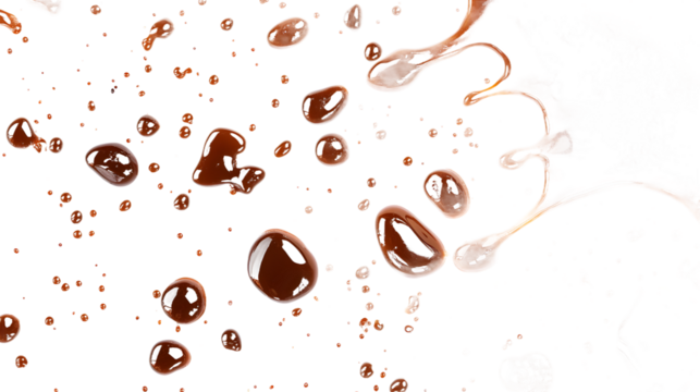 Delicious chocolate splashes and droplets creating an artistic chaos on a dark background.