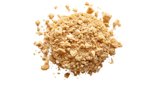 Close-up of finely crushed graham cracker crumbs on a white background, highlighting texture and color.