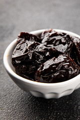 Prunes dried fruit smoked plum snack fresh delicious gourmet food background on the table rustic food top view copy space keto and paleo diet vegetarian and vegan food