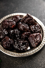 Prunes dried fruit smoked plum snack fresh delicious gourmet food background on the table rustic food top view copy space keto and paleo diet vegetarian and vegan food