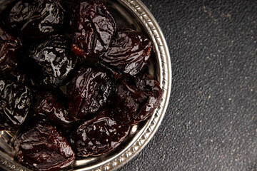 Prunes dried fruit smoked plum snack fresh delicious gourmet food background on the table rustic food top view copy space keto and paleo diet vegetarian and vegan food