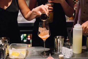 Bartender Pouring Cocktail Into Wine Glass.