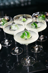 Modern cocktails with herb and berry ice spheres.