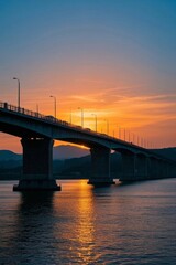 Fototapeta premium arafed bridge over a body of water with a sunset in the background