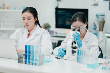 Researchers collaborate in a cutting-edge DNA laboratory, analyzing samples on petri dishes to...