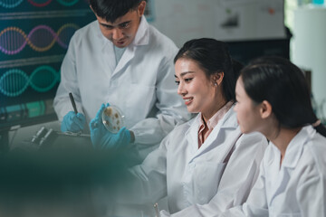 Researchers collaborate in a cutting-edge DNA laboratory, analyzing samples on petri dishes to...