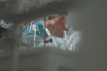 Researchers collaborate in a cutting-edge DNA laboratory, analyzing samples on petri dishes to...