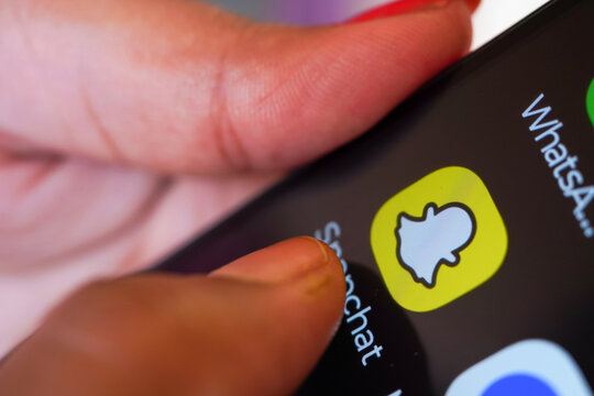West Bengal, India - May 16, 2025; The American multimedia instant messaging app Snapchat on an Android phone with a finger going towards opening the application.