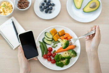 young female planning menu to eat ketogenic diet during weight loss program.