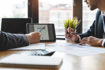 financial advisory services. Asian advisor showing plan of investment to clients in the consultancy office.