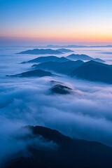 Naklejka premium arafed view of a mountain range with a layer of clouds