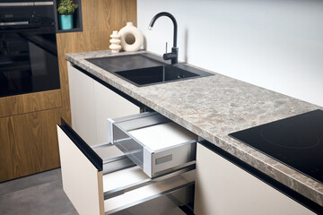 Horizontal sliding pull out drawer cabinet shelves storage in kitchen cupboard with beige panels...