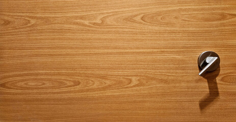 Close up wooden cabint or cupbord background. Wood locker with stainlees steel handle and copy space.