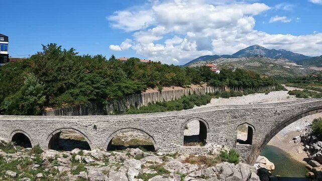 A view of the Ottoman Mesi Bridge near Shkoder in northwestern Albania. Mesi bridge with tourists