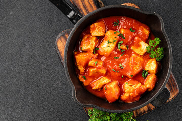 Butter chicken curry poultry meat tomato sauce dish fresh tasty gourmet food background on the table rustic food top view copy space