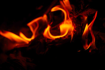 soft focus photo of beautiful fire flames with reflection on dark background.