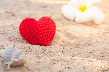 sweet heart on sand beach under sunset and warm light.
