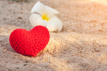 sweet heart on sand beach under sunset and warm light.