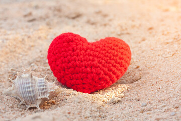 sweet heart on sand beach under sunset and warm light.
