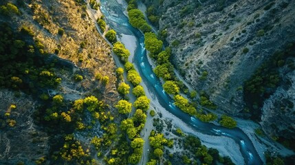 Obraz premium Aerial View of Serene River Flowing Through Lush Green Valley