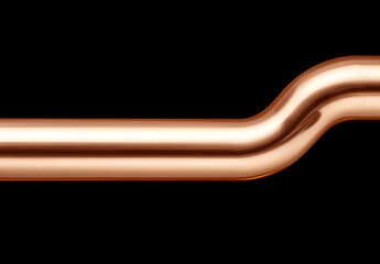 A shiny copper pipe curves against a black background. The pipe gleams in the light, showcasing its smooth, metallic surface and gentle bend.