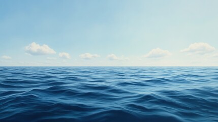 Obraz premium Vast ocean under a clear blue sky with gentle waves and scattered clouds on the horizon. Serene and calming scene.