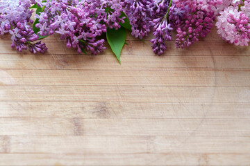 lilac flower arrangement on old board background with free space