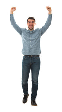 Full length portrait of a cheerfull young man celebrating as raising hands up like a winner isolated on transparent background