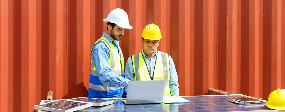container operators wearing helmets and safety vests meeting about logistics operations in container yards. Colleagues Talk About Logistics Operations