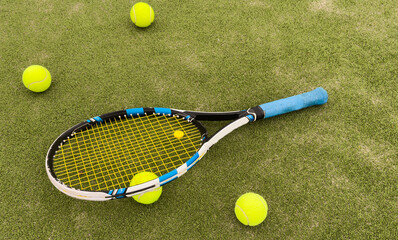 Tennis racket and ball on green background. Flat lay. Sports equipment