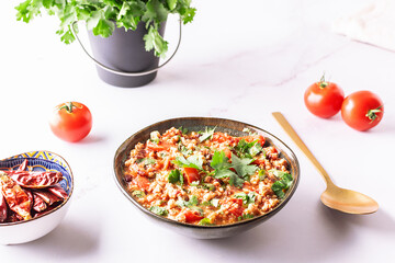 Traditional hot chili con carne in ceramic bowl on white marble table close up. tasty homemade food concept.
