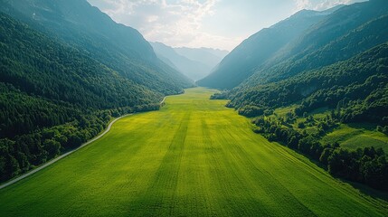 Vast valley stretching through lush green fields and mountains.