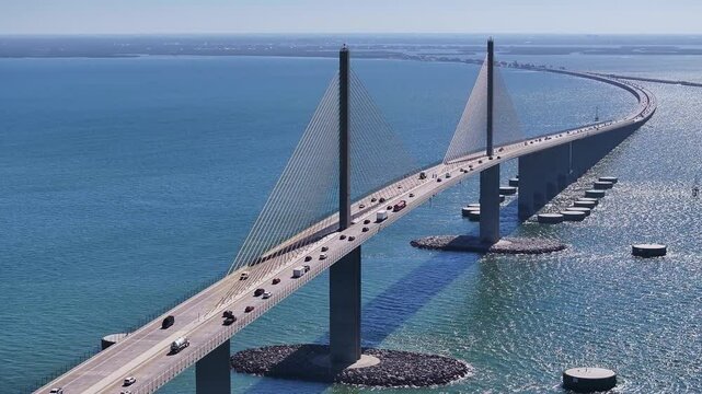 Sunshine Skyway Bridge At Saint Petersburg Florida United States. Powerful Landscape Of The Vehicles In A Famous Road . Shore Clouds Beach Sea. Seaside Panning Wide. Saint Petersburg Florida.