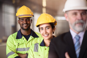 Professional Industrial Team with Factory Manager Standing Together in Manufacturing Facility