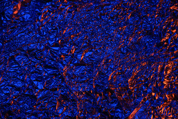 Red and blue Shiny aluminum foil texture close up