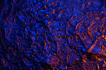 Red and blue Shiny aluminum foil texture close up