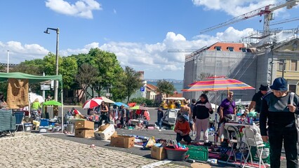 Sunlit flea market scene, bustling diversity and vibrant hues, capturing Autumn Equinox festival...