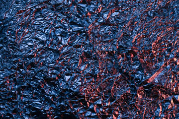 Red and blue Shiny aluminum foil texture close up