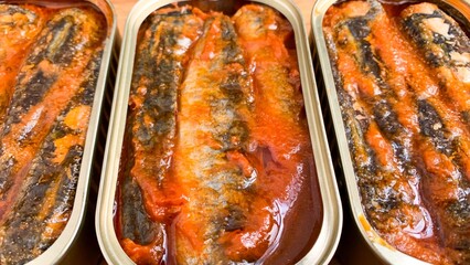 Rich sardine fillets in sunset-hued tomato glaze, evoke coastal nostalgia and the quaint charm of...