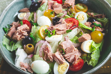 salad with canned tuna, vegetable salad with quail eggs, lettuce, red onion , cherry tomatoes , olives, keto food, healthy food, homemade, no people