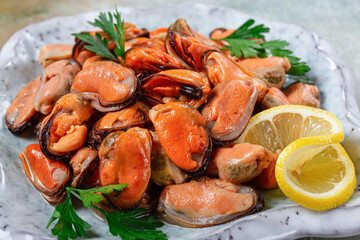 mussels no shell, boiled, mussels, peeled, in a bowl, with lemon and parsley, Chilean mussels, top view, no people,