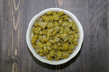 Top view of a bowl with plain cooked diced nopales  (cactus), commonly used in Mexican cuisine.