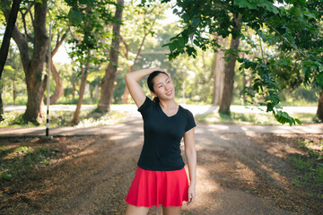 Asian women are stretching their muscles before going out to run to the park to keep themselves...