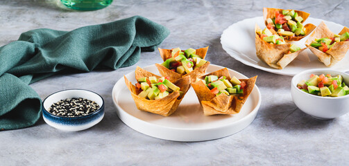 Appetizing cups of guacamole in pita bread on a plate on the table web banner