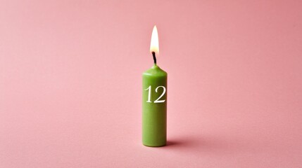 Burning green candle with the number 12