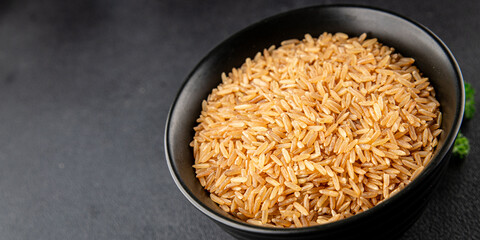 Brown rice whole grain cereal healthy product superfood fresh tasty gourmet food background on the table rustic food top view copy space keto and paleo diet vegetarian and vegan food