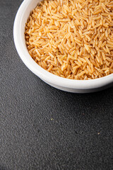 Brown rice whole grain cereal healthy product superfood fresh tasty gourmet food background on the table rustic food top view copy space keto and paleo diet vegetarian and vegan food