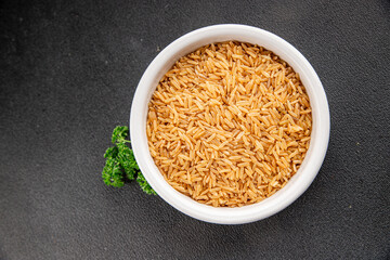 Brown rice whole grain cereal healthy product superfood fresh tasty gourmet food background on the table rustic food top view copy space keto and paleo diet vegetarian and vegan food